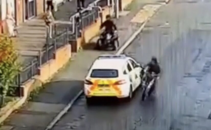 Scooter Rider Kicks Cop Car But The Cop Car Unwinds